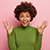 emotive-surprised-curly-woman-raises-hands-with-jo-EQGLN6V